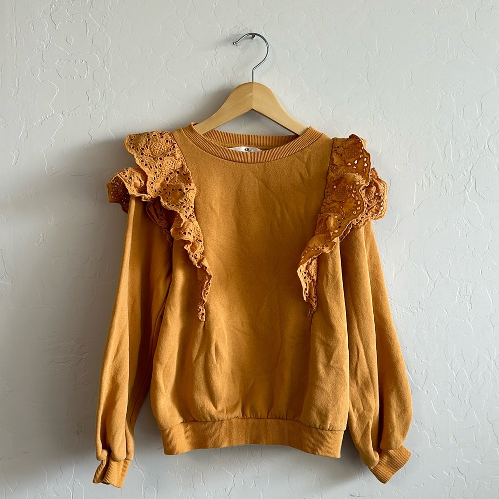 Girls sweater with crochet detail.